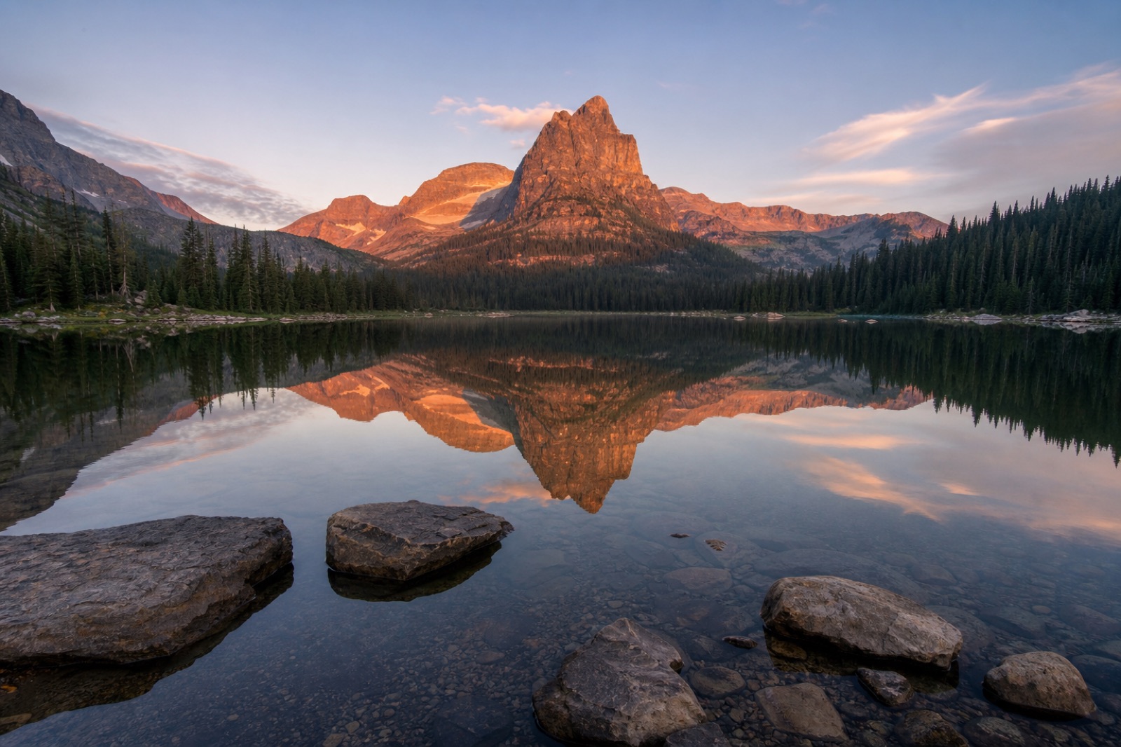 Mountain reflected in a still lake at sunset